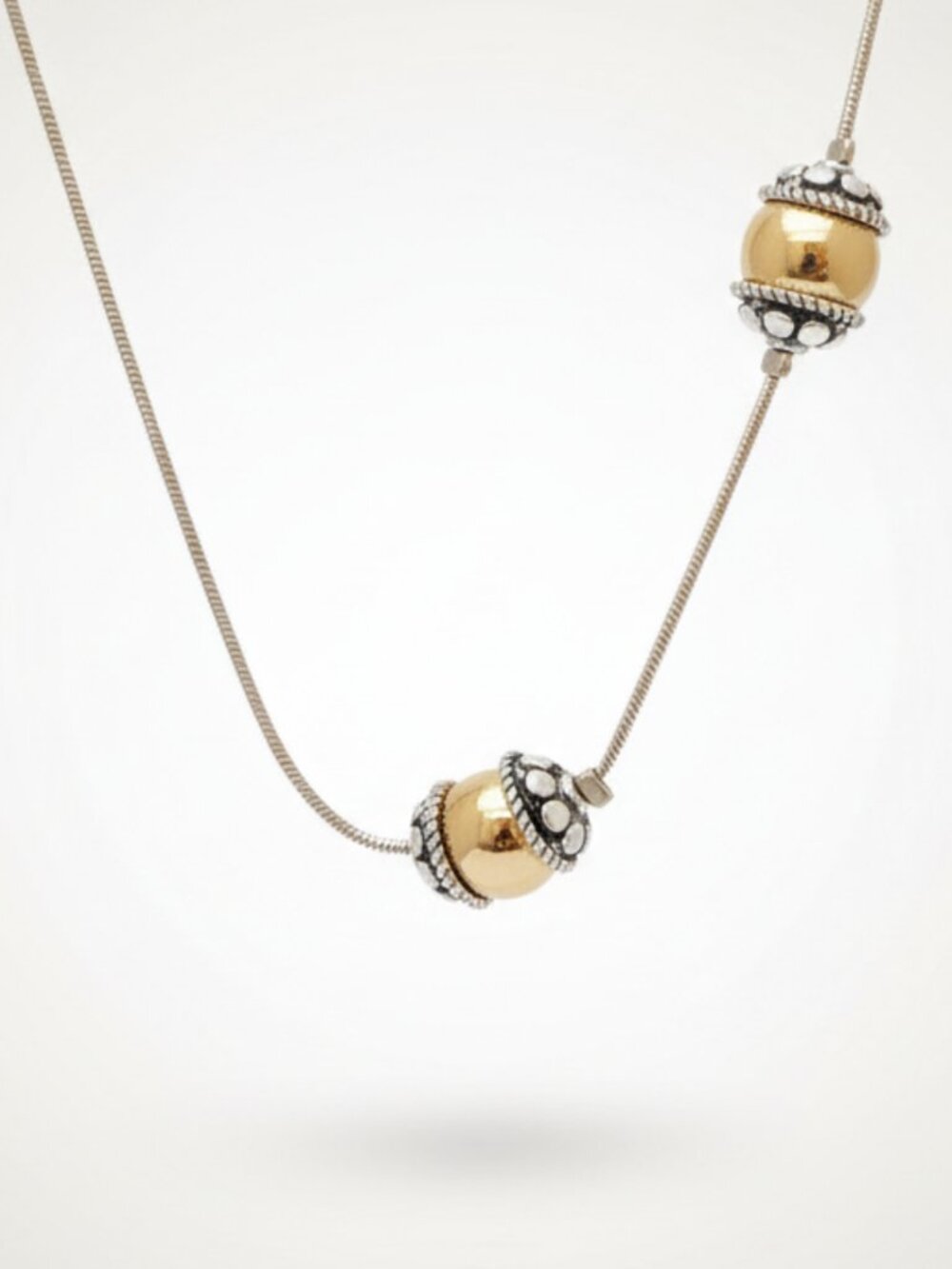 Silver-toned necklace accented by golden and silver spherical beads. Brand new. - Picture 2 of 3